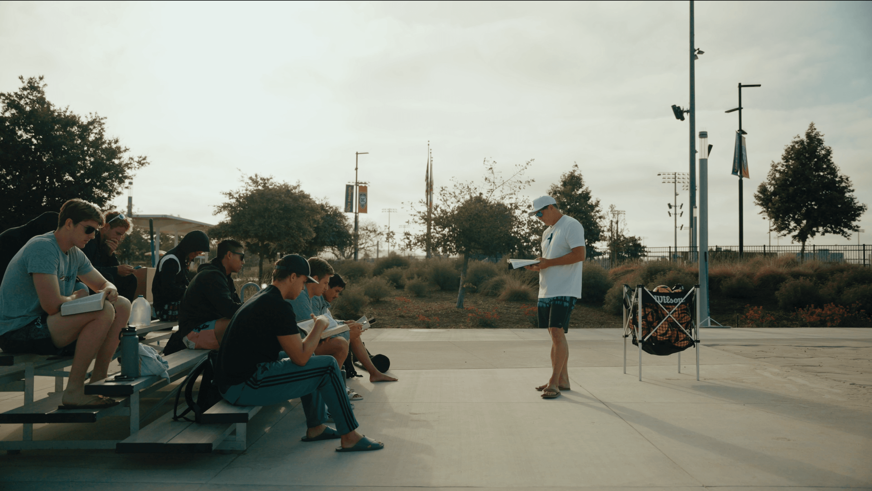 Michael leading Bible study on bleachers